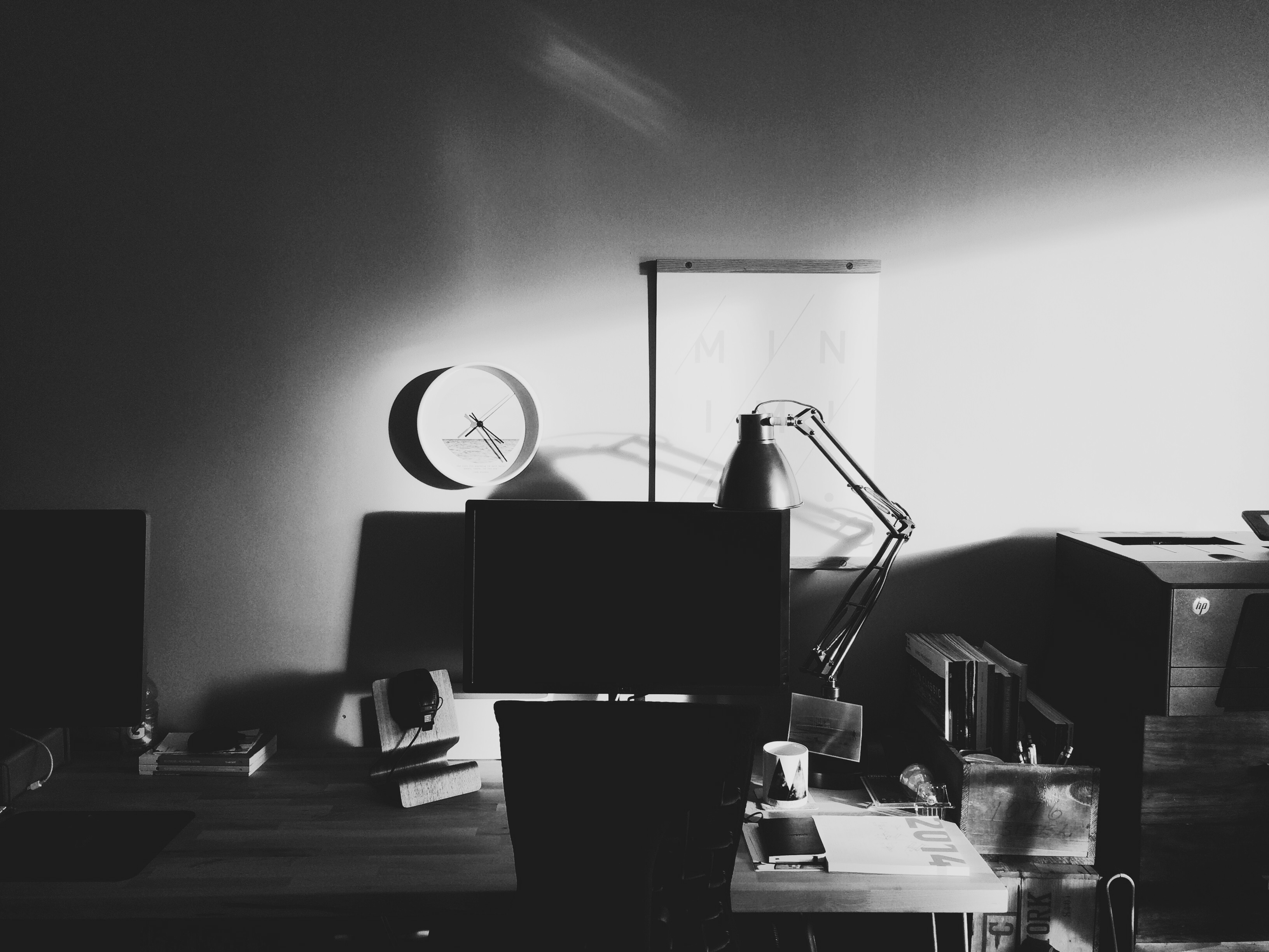 black and white photo of my desk in the late afternoon light